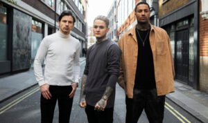 "Young people in London wearing denim jackets in unique colors like grey and white, showcasing diverse street style trends."
