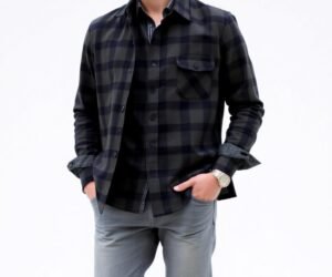 "Man wearing grey pants with a black checked shirt, styled for a casual yet polished appearance"