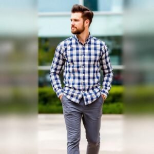 "Man dressed in grey pants and a checked shirt, showing a balanced and stylish casual look"