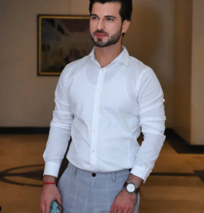 Man wearing grey pants with a white button-down shirt in a stylish outfit