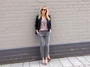 Man pairing grey pants with colorful floral tops for a bold, fashionable outfit
