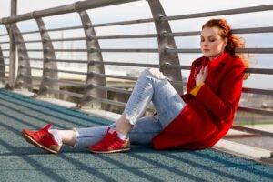 Woman styling grey pants with a bold colorful top for a confident, modern look