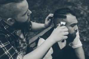 Modern interpretation of the Martin Luther King haircut featuring a low taper fade with a clean mustache.