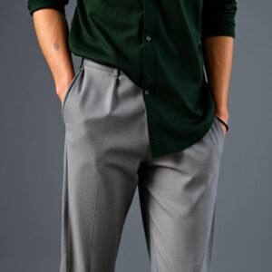 Man wearing a dark green shirt with grey trousers in a smart casual outfit